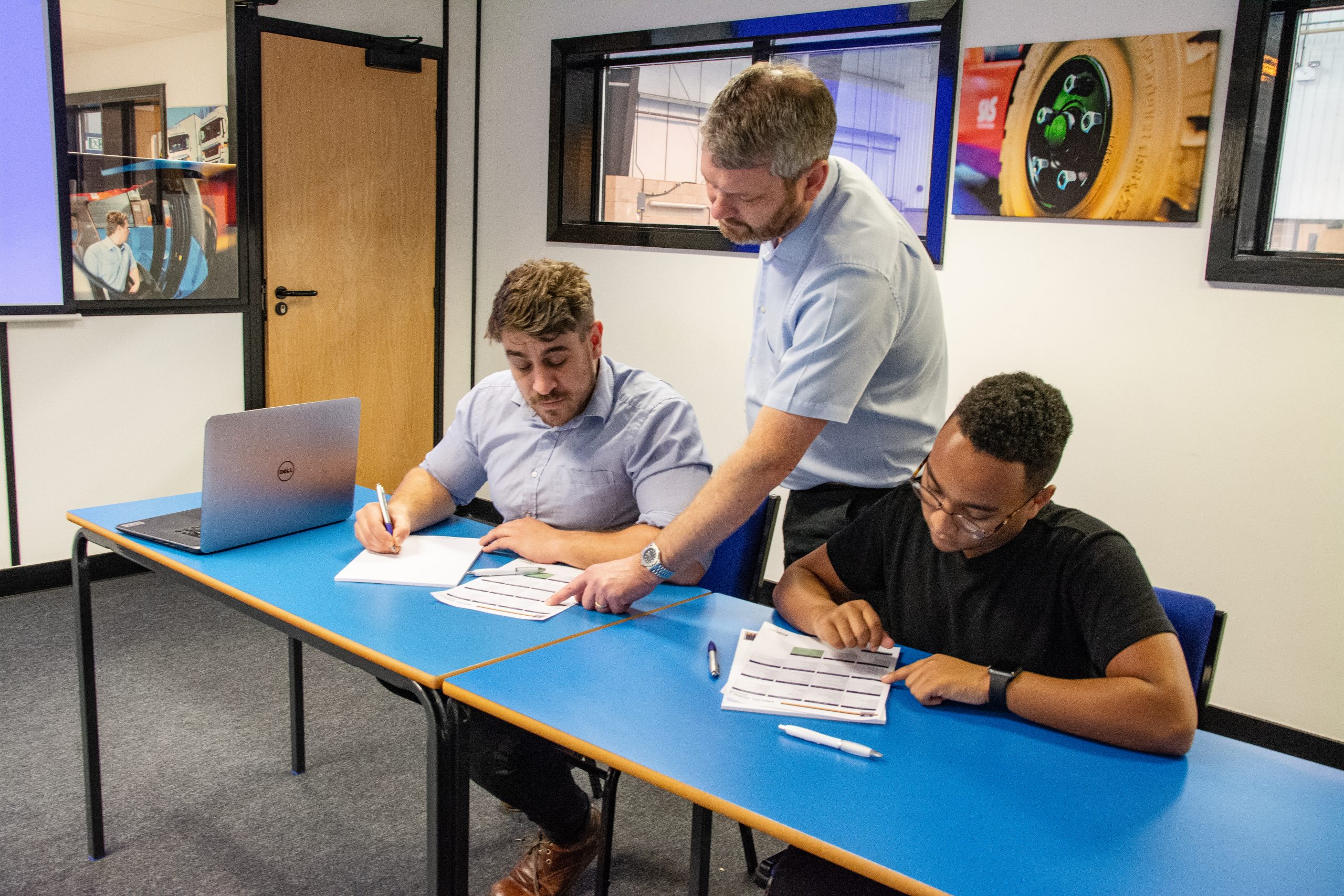 three men observing paperwork